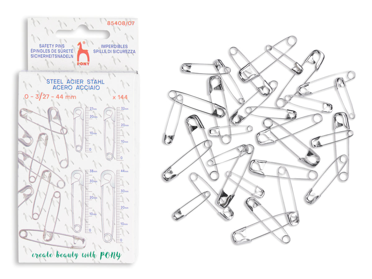 Pack of 144 steel safety pins in size 0-3/27 - 44 mm, shown next to the retail packaging on a white background. The pins are made of silver-colored steel and are arranged loosely on the right side.