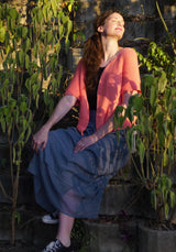 Circulo Aloe Vera Yarn 121m / 100g - Woman in a pink cardigan and blue dress sitting among plants
