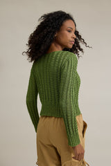 Circulo Cordone 100% Polyamide Crochet Yarn, 450 m / 100 g - Woman wearing a green knitted sweater and beige pants against a neutral background